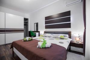a bedroom with a bed with a brown and white bedspread at VisitZagreb Emerald in Zagreb