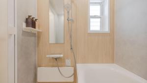 a bathroom with a shower with a sink at First Choice Minami Kamata in Tokyo