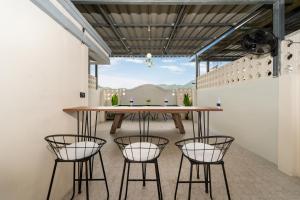 a dining room with a table and four chairs at Wink 3 Patong Beach Phuket sleep 8 in Ban Nong Chaeng