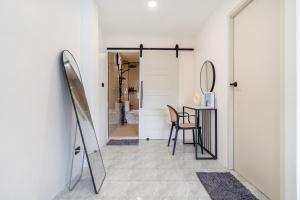 a hallway with a table and chairs and a mirror at Wink 3 Patong Beach Phuket sleep 8 in Ban Nong Chaeng +57 photos