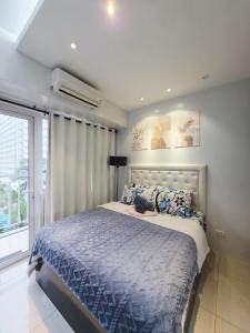 a bedroom with a bed with a cat laying on it at Andengs Cozy place in Manila