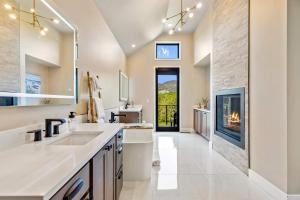 a bathroom with a fireplace and a large sink at Pagoda Peaks - Modern Luxury Near Bozeman Beach in Bozeman