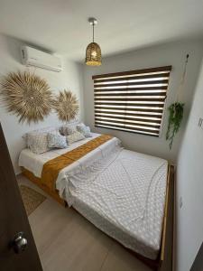a bedroom with a bed and a large window at Casa Las Palmas in Mazatlán