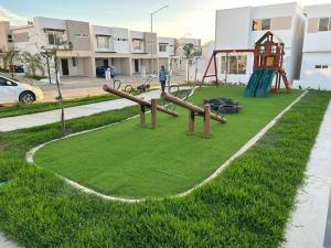 a park with a playground with a slide at Casa Las Palmas in Mazatlán
