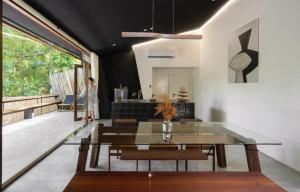 a living room with a glass table and a couch at Hunter house in Ban Bung Toei