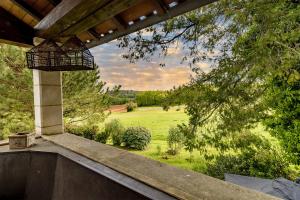 a view of a field from the porch of a house at Maison Croix du sud. Chambre Fruits de la Passion in Saint-Amand-de-Vergt