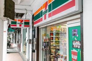 a store front of a grocery store with its doors open at A Hotel Chinatown, 11 Hrs, Stay From 10PM - 9AM in Singapore