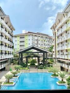 a view of an apartment complex with a swimming pool at Cozy condo unit at Amani Grand near Cebu Airport in Pusok