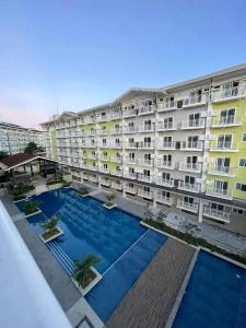 an image of an apartment building with a swimming pool at Cozy condo unit at Amani Grand near Cebu Airport in Pusok +22 photos