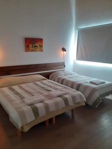 a bedroom with two beds and a window at El mejor descanso II in Plottier
