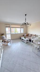 a living room with a couch and a table at Karchevi Apartment in Sveti Vlas