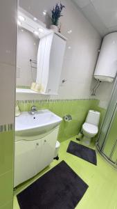 a bathroom with a white sink and a toilet at Karchevi Apartment in Sveti Vlas +21 photos