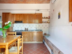 a kitchen with wooden cabinets and a wooden table at Peccioli Family Retreat w Fun in Peccioli