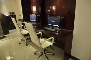 a office with three chairs and a desk with a computer at The Grande Suites in Surigao +7 photos