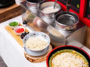 a counter with bowls of noodles and other ingredients at APA Hotel AkihabaraSuehirocho Ekimae -Electric Town- in Tokyo