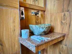 a bathroom with a stone sink on a counter at The Urban Retreat- A Boutique Hotel with Grand View in Manāli +43 photos