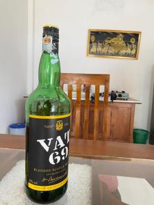 a green bottle of wine sitting on a table at Villa Lee Polhena in Matara