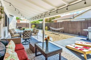 un patio avec un canapé et une table dans l'établissement Jacuzzi & Pool House w/Game Room + Fire table, à The Colony
