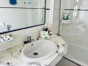 a white bathroom with a sink and a shower at Oasis del Sol in Costa Calma +13 photos