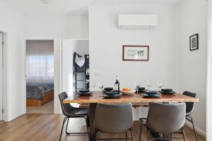 a dining room with a wooden table and chairs at The Crystal Palace 2 in Jindabyne