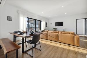 a living room with a couch and a table at The Crystal Palace 2 in Jindabyne