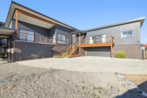 a house with a large driveway in front of it at The Crystal Palace 2 in Jindabyne