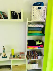 a childs room with white shelves and books at Oasis del Sol in Costa Calma