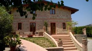 a stone house with stairs leading up to it at Agriturismo Aurea in Torretta