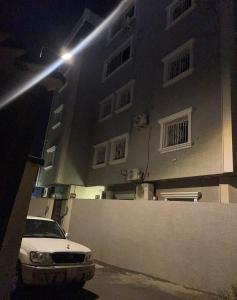 a car parked in front of a building at night at شقة فاخرة بأبها in Abha