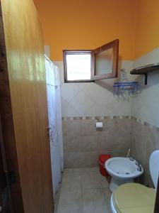 a bathroom with a toilet and a sink at Casa familiar de Campo Arev in Las Rabonas