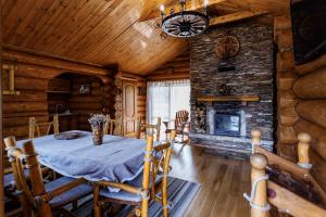 a dining room with a table and a fireplace at Ray Eco Resort in Mukacheve