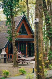 a person sitting on a hammock in front of a cabin at Meselik Park Bungalov in Sapanca