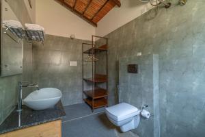 a bathroom with a toilet and a sink and a shower at Ravishing Retreat Resort in Rāmanagaram