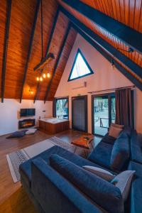a living room with a blue couch and a large window at Meselik Park Bungalov in Sapanca