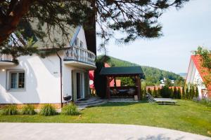 a house with a porch and a bench in the yard at Chata Achát in Turany nad Ondavou