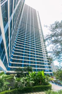 a tall building with trees in front of it at Makati Bliss Designer Stay Pool gym park Net300 makati 1767 in Manila