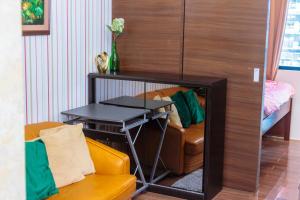 a living room with a couch and a table at Makati Bliss Designer Stay Pool gym park Net300 makati 1767 in Manila +58 photos