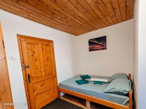 a small bedroom with a bed and a wooden ceiling at Summer Vibe Costinesti in Costinesti