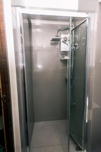 a shower stall with a glass door in a bathroom at Metro Paradise 1BR Comfort Makati swim gym park 300MB 2320 in Manila