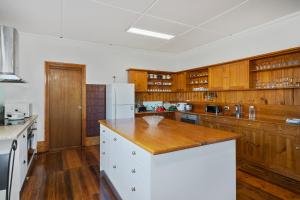 a kitchen with wooden cabinets and a wooden counter top at Franklin Lodge, Huon Valley, Tasmania, Lavender Room in Franklin