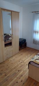 a room with a bedroom with a closet and a mirror at Pet friendly Landhaus in Modriča