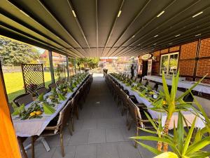 an outdoor patio with tables and chairs and plants at Hotel Zum Böhmegrund in Bad Fallingbostel