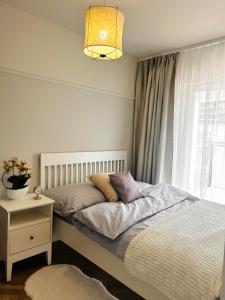 a bedroom with two beds and a window at Downtown Apartments Podpromie Monica with UNDERGROUND PARKING in Rzeszów