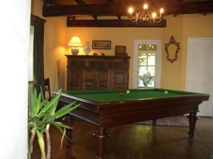 a living room with a pool table in a room at Manoir de Kerliviry in Cléder