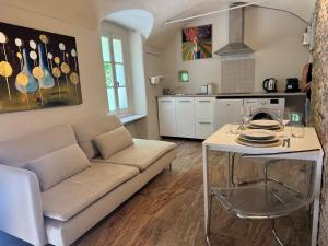 a living room with a couch and a table at La piazzetta in Arma di Taggia