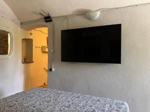 a flat screen tv on the wall of a bedroom at La piazzetta in Arma di Taggia