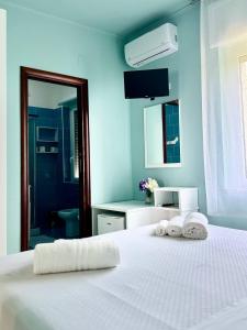 Postel nebo postele na pokoji v ubytování B&B Riviera Azzurra