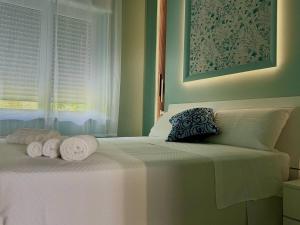 Postel nebo postele na pokoji v ubytování B&B Riviera Azzurra