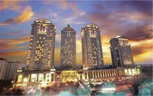 a group of tall buildings in a city at night at 2 Bedroom apartment at Senayan in Jakarta