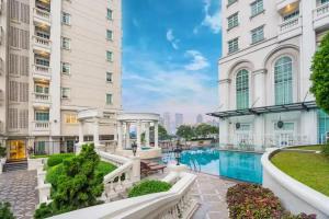 a building with a swimming pool in front of a building at 2 Bedroom apartment at Senayan in Jakarta